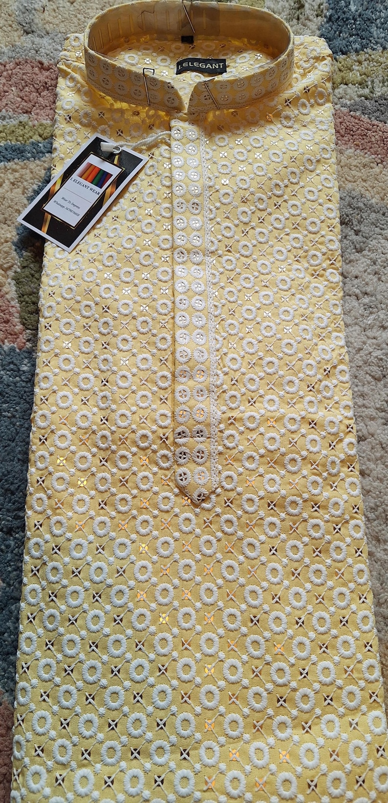 May include: A yellow kurta with white embroidery and sequins. The kurta has a mandarin collar and a button closure. The fabric is lightweight and breathable, making it perfect for warm weather.