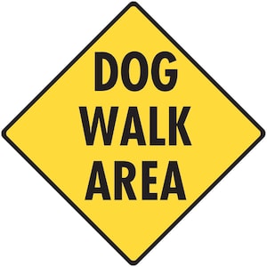 May include: A yellow diamond-shaped sign with black text that reads "DOG WALK AREA".
