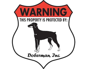 May include: A red and white warning sign with a black silhouette of a Doberman Pinscher. The sign reads "Warning This Property Is Protected By: Doberman, Inc."