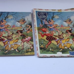 May include: Vintage jigsaw puzzle depicting fairies and a rabbit dancing in a forest. The puzzle is partly assembled, with the box art visible. The box reads "Victory Jigsaw Puzzle" and "Children 5 to 10 years old."