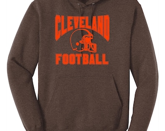 May include: A brown hooded sweatshirt with the text "CLEVELAND FOOTBALL" in orange lettering and a football helmet graphic.