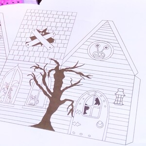 Completed printable in 2D haunted house showcasing how the right side and back looks upclose . It features detailed Halloween elements including a witch, alien, large door, and a large tree.