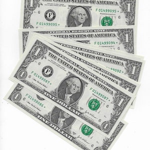 May include: A stack of eight US one dollar bills with the text "Federal Reserve Note" and "The United States of America" printed on them. The bills are all in good condition and have the same serial number, F01499087.
