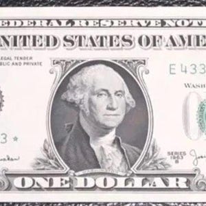 May include: A one dollar bill featuring a portrait of George Washington. The bill has a green seal with the letter "G" and the words "Washington, D.C." The bill also has the serial number "E 43337993".