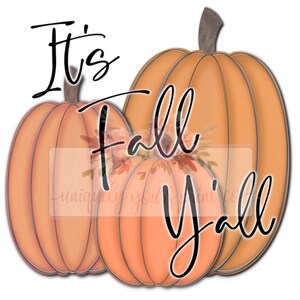 May include: It's Fall Y'all text with three orange pumpkins. The pumpkins have a textured surface and are arranged in a row.