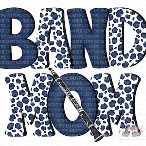 May include: A graphic design featuring the words "BAND MOM" in a bold, navy blue font with a white and navy blue leopard print pattern. A black and silver clarinet is positioned across the letters.