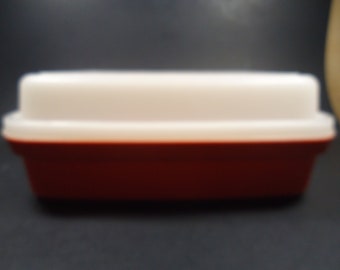 Tupperware orange  marinade container with white lid.