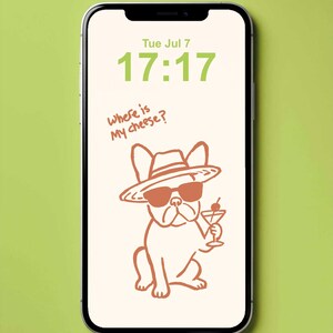 A smartphone displaying a digital wallpaper with a light cream background and a stylized orange illustration of a French Bulldog wearing a sunglasses, hat and holding a martini drink. The screen shows the green text "Tue Jul 7" and the time "17:17" in a bold font.