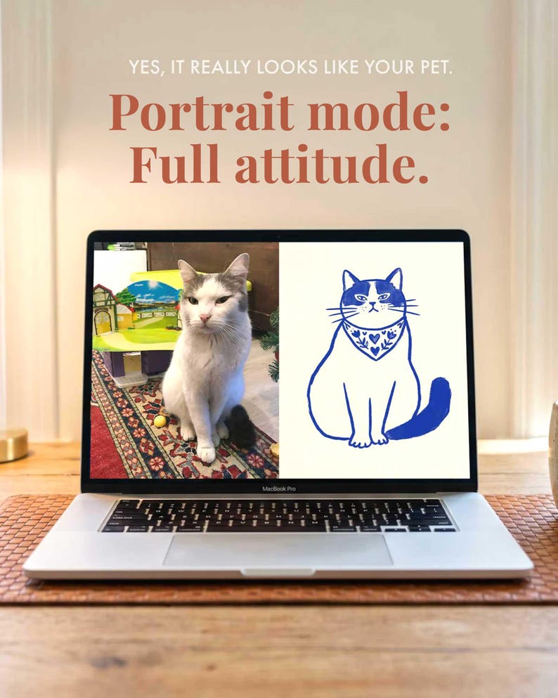 May include: A silver laptop screen displays a split image featuring a photograph of a white and grey cat on the left and a blue line art illustration of the same cat wearing a patterned bandana on the right. Text above reads: YES, IT REALLY LOOKS LIKE YOUR PET. A photo remembers. A portrait is a tribute.