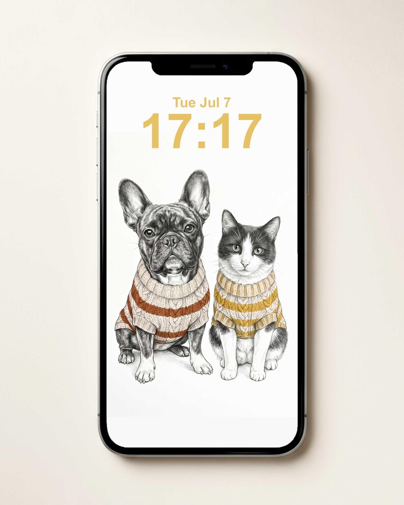 A smartphone displaying a digital illustration of a French Bulldog and a cat sitting side-by-side, both wearing cable-knit sweaters. The screen shows the date Tue Jul 7 and the time 17:17 in a gold font against a white background.