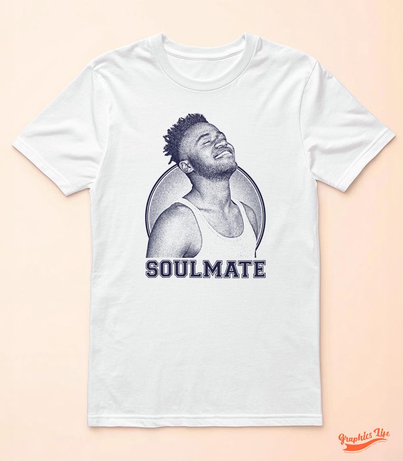 May include: White t-shirt featuring a blue and white illustration of a person with the word "SOULMATE" printed below.