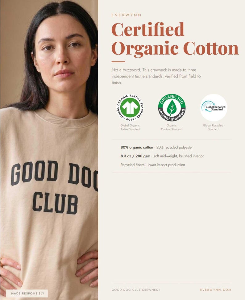 May include: A beige crewneck sweatshirt featuring the black text GOOD DOG CLUB on the front. The garment is composed of 80% organic cotton and 20% recycled polyester, weighing 8.3 oz, with a soft brushed interior and certified textile standards.