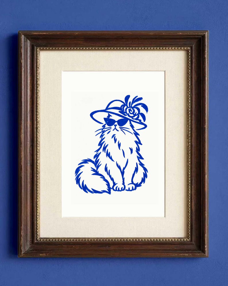 A framed art print featuring a blue ink illustration of a Maine Coon cat on a white background. Cat is wearing sunglasses and a Kentucky Derby Hat.