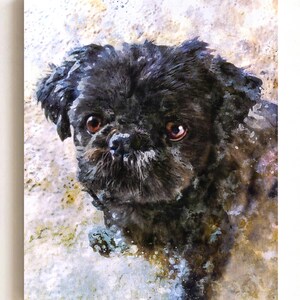 May include: A rectangular wall art print featuring a watercolor-style portrait of a small black dog with large brown eyes and a textured, shaggy coat. The artwork uses splattered paint effects in shades of beige, white, and gray around the dog.