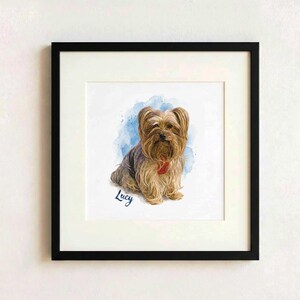 May include: A framed print featuring a watercolor illustration of a Yorkshire Terrier with tan and grey fur, wearing a red collar. The dog is positioned against a blue watercolor splash background with the name Lucy written in blue script below.