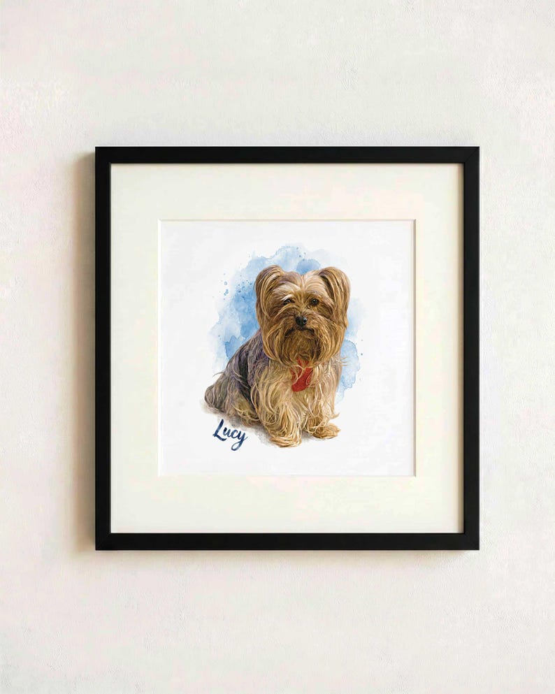 May include: A framed print featuring a watercolor illustration of a Yorkshire Terrier with tan and grey fur, wearing a red collar. The dog is positioned against a blue watercolor splash background with the name Lucy written in blue script below.