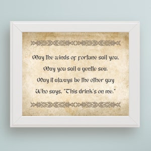 May include: A framed print with a vintage background and a Celtic knot border. The text reads: "May the winds of fortune sail you, May you sail a gentle sea. May it always be the other guy who says, "This drink's on me."