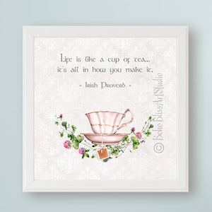 May include: A white framed print with a watercolor illustration of a teacup and saucer with a tea bag hanging from the saucer. The print features the text "Life is like a cup of tea... it's all in how you make it. - Irish Proverb -"