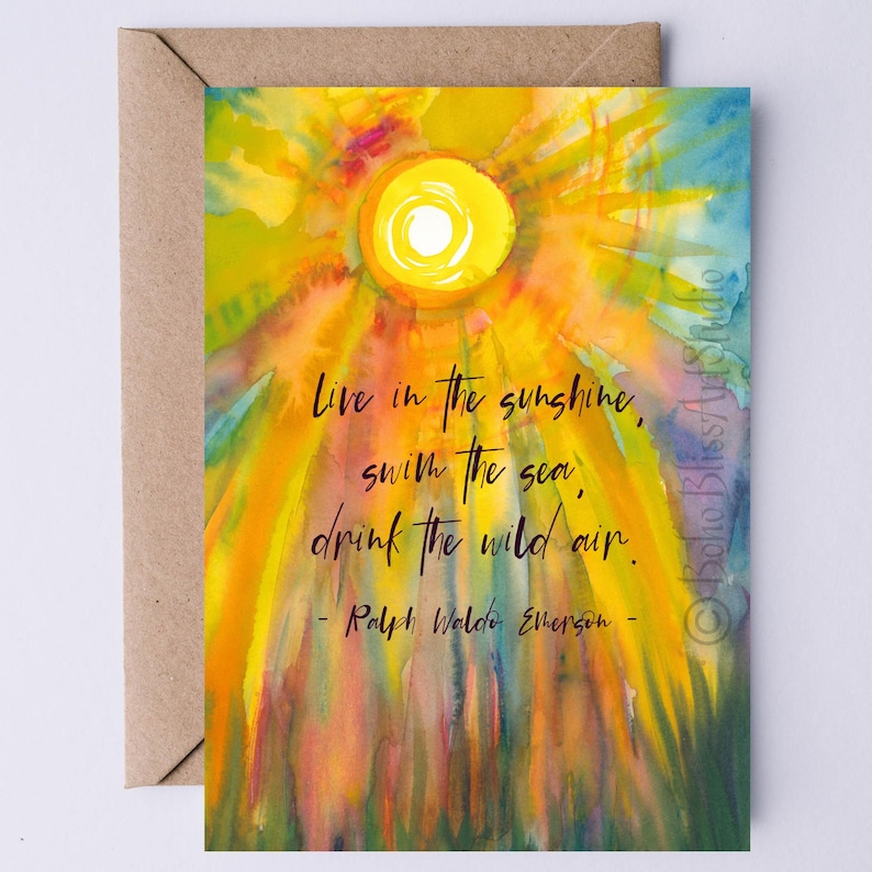 live in the sunshine swim the sea drink the wild air quote by Ralph Waldo Emerson printable card nature quote is printed on a watercolor painting of the sun in bright yellow and orange against a sky of teal and aqua