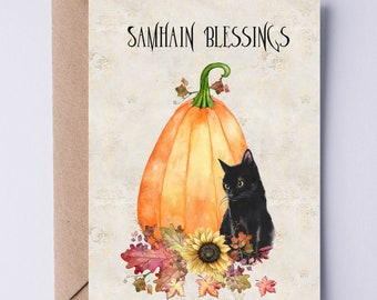 May include: Greeting card with a watercolor illustration featuring a large orange pumpkin, a black cat, and autumn leaves. The text "SAMHAIN BLESSINGS" is at the top. The card is paired with a brown envelope.