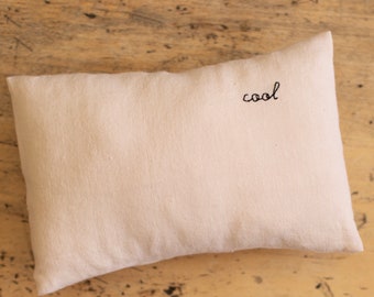 Mini hand-embroidered washed linen cushion