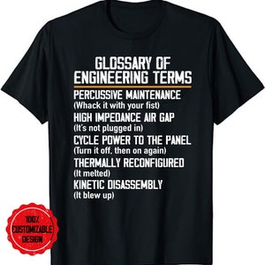May include: Black t-shirt featuring the text "Glossary of Engineering Terms" in white. The shirt lists humorous definitions for engineering terms like "Percussive Maintenance" and "Kinetic Disassembly." A red circular logo with "100% Customizable Design" is in the lower left.