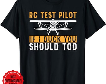 May include: Black t-shirt with white text that reads "RC Test Pilot If I Duck You Should Too". A white silhouette of a small airplane is above the text.