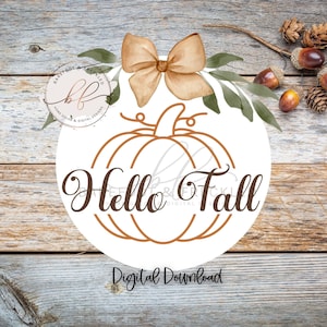 May include: A white circle with a brown outline of a pumpkin and the text "Hello Fall" in brown cursive lettering. A brown bow with green leaves is above the pumpkin. The background is a woodgrain texture.