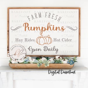 May include: A digital download sign for a farm stand featuring the text "Farm Fresh Pumpkins", "Hay Rides", "Hot Cider", and "Open Daily". The sign is on a white background with a brown wood frame. The text is in a rustic font and the pumpkins are orange.