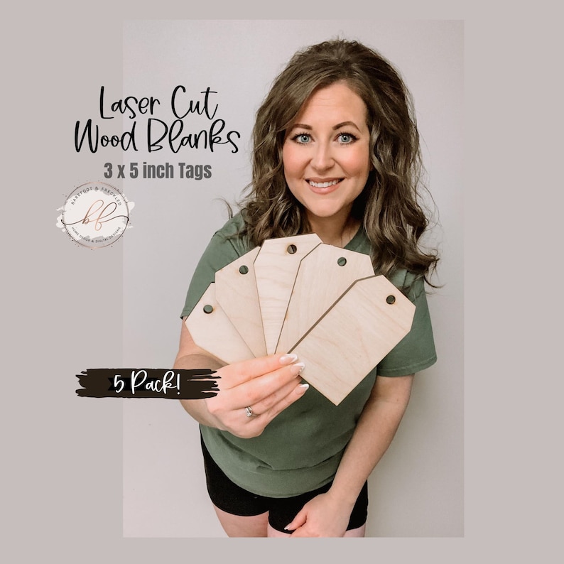 May include: A woman holds a pack of five laser cut wood blanks. The blanks are 3 x 5 inch tags. The text "Laser Cut Wood Blanks" and "3 x 5 inch Tags" is printed on the image. The text "5 Pack!" is also printed on the image.