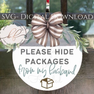 May include: A white round door hanger with the text "PLEASE HIDE PACKAGES from my husband" in black and teal lettering. A brown and white striped bow with a green leafy sprig is attached to the top of the hanger.