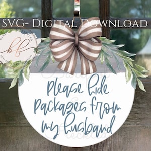 May include: A round white door hanger with a blue watercolor background and the text "Please hide packages from my husband". The hanger is decorated with a brown and white striped bow and green leaves.
