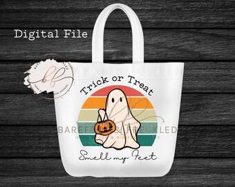 May include: White tote bag with a retro-style graphic of a ghost holding a pumpkin and the text "Trick or Treat Smell my Feet".