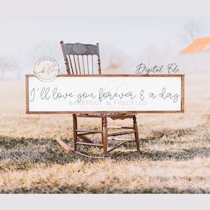May include: A white wooden sign with the text "I'll love you forever & a day" in black cursive font. The sign is sitting on a rocking chair in a field of brown grass. The sign is from the shop "Barefoot & Freckled Home Decor & Digital Designs."