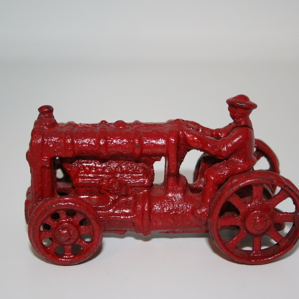 Vintage cast iron red tractor with farmer 3 1/2" long x 2 3/4" wide x 2 1/4" tall