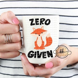 May include: White ceramic mug with a black and orange fox illustration and the text "Zero Given".