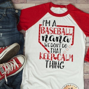 May include: White and red baseball raglan shirt with the text "I'M A BASEBALL nana WE DON'T DO THAT KEEP CALM THING". The shirt is paired with blue jeans and red Converse sneakers.