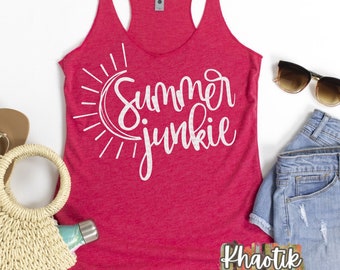 May include: A red tank top with the text "Summer Junkie" in white lettering. The text is accompanied by a graphic of a sun and moon.