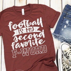 Puede incluir: Una camiseta marrón con texto blanco que dice "Football is my second favorite F-word".