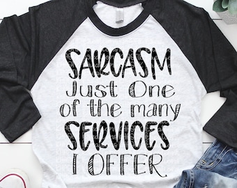 May include: A white and gray raglan style t-shirt with black sleeves. The shirt features the text "Sarcasm Just One of the many SERVICES I OFFER" in a black, handwritten font. A pair of blue jeans and white sneakers are also in the image.