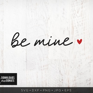 May include: White wood background with black cursive text that says "be mine" and a small red heart.
