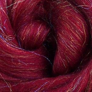 May include: A close-up of a deep red wool roving with iridescent gold and blue fibres woven throughout.