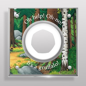 May include: Square framed artwork featuring a forest scene with a circular, silver-colored element in the center. The text "Oh help! Oh-no! It's a gruffalo!" is written on the artwork. The artwork is set against a white background.