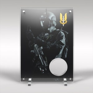 May include: A black and white image of a soldier wearing a gas mask and holding a rifle. The soldier is standing in front of a black background with a gold emblem that says "Who Dares Wins".