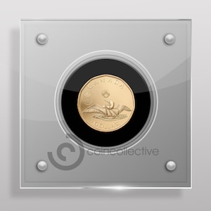 May include: A gold Canadian dollar coin featuring a loon with the text "CANADA" and "DOLLAR" on the coin. The coin is displayed in a clear acrylic case with a black background.