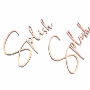 May include: Two wooden signs with the word "Splash" written in cursive script. The signs are light brown and have a rustic look.