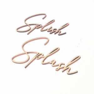 May include: Two wooden signs with the words "Splish" and "Splash" written in a cursive font.