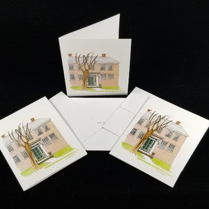 May include: Three white folded cards with a watercolor illustration of a pink house with a green door and a bare tree in front. The house has three windows on each floor and a chimney on the roof. The cards are blank inside and can be used for greeting cards, thank you notes, or invitations.