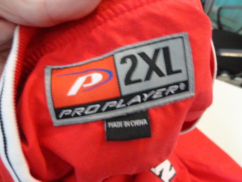 May include: Red and grey Pro Player brand label with the text "2XL" and "Pro Player" with a white and blue logo. The label also says "Made in China".