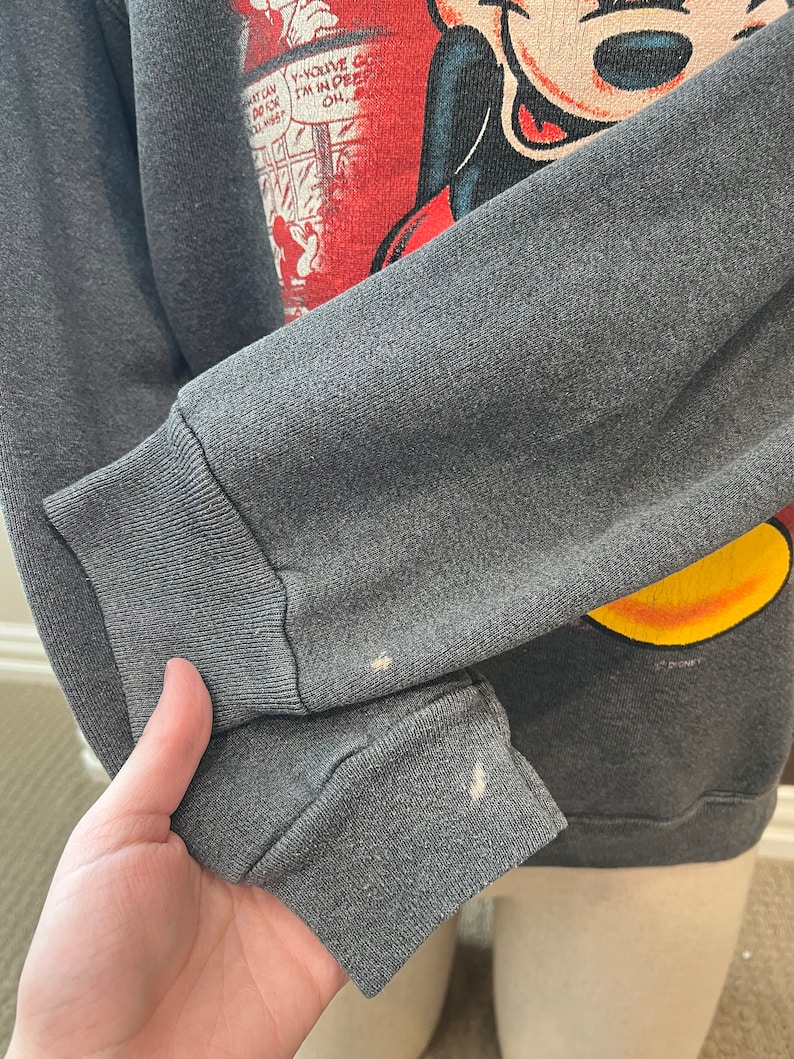 May include: A gray sweatshirt with a vintage Mickey Mouse graphic. The graphic features Mickey Mouse in a red and yellow outfit with the text "You've Got It, I'm In Deep, Oh..." in a speech bubble.